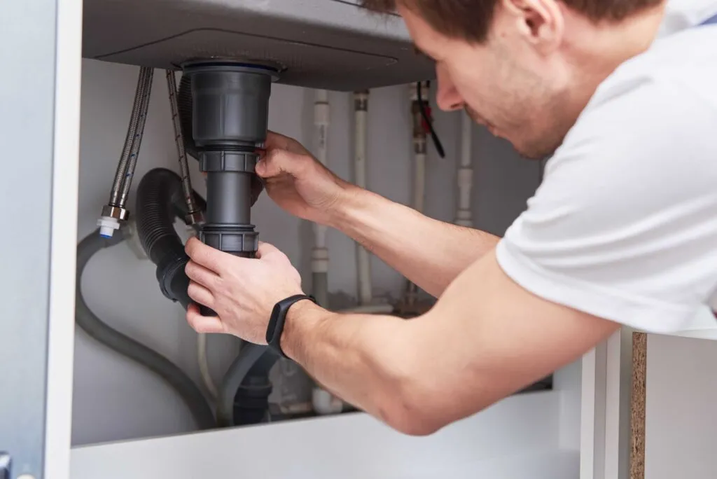 male-plumber-repair-sink-pipe-in-kitchen-2022-12-16-12-45-16-utc_optimized